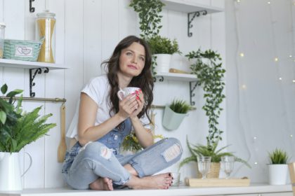 Life-work balance concept. Portrait of smiling lady posing in bright home apartments.