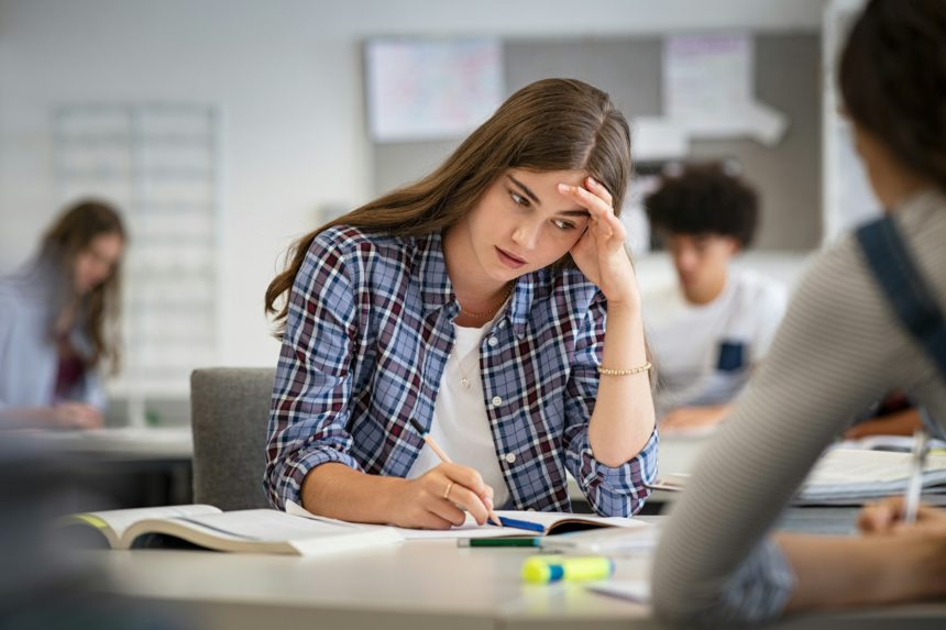 Stressed and worried girl durig exam at school