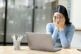 Tired and stressed business woman at a desk for a long time and has office syndrome