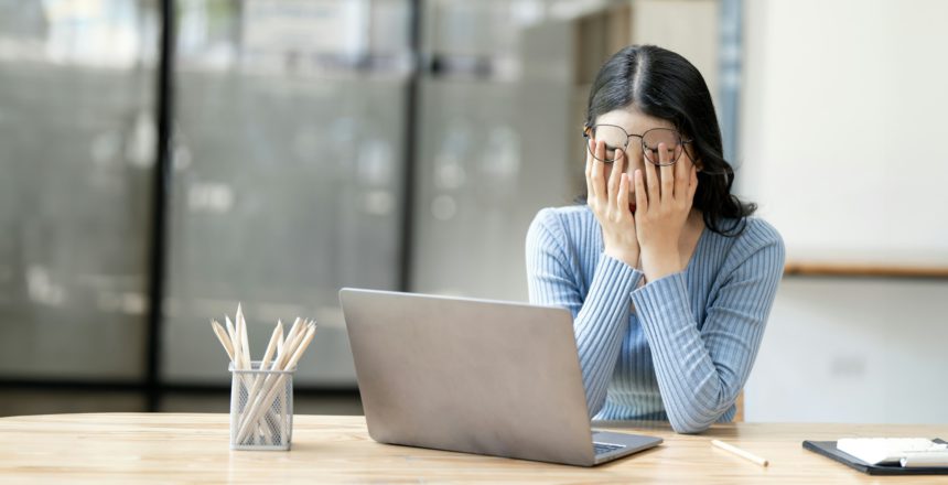 Tired and stressed business woman at a desk for a long time and has office syndrome